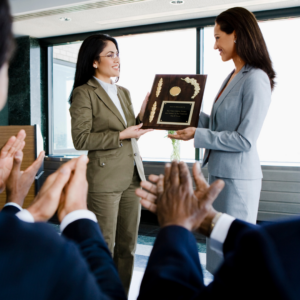 woman being presented with engraved plaque award